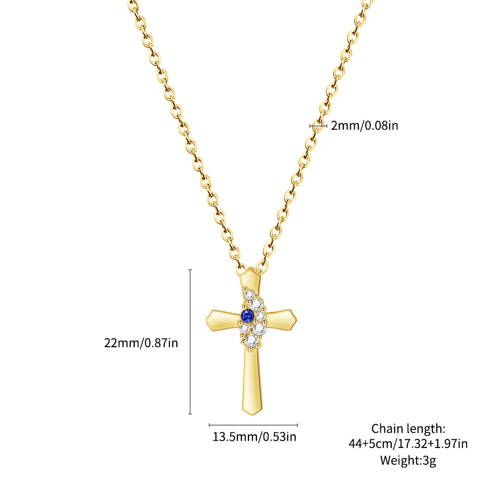 Gold cross necklace with measurements on a white background